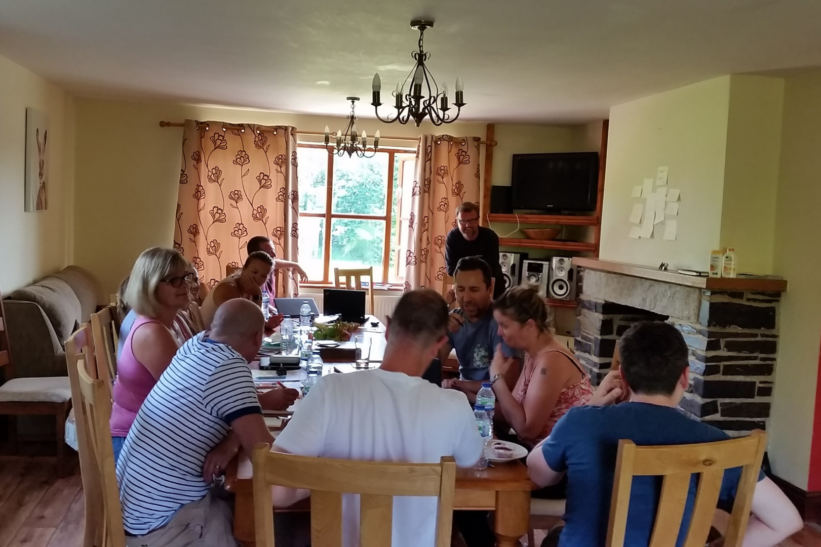 Group sat at table Sherrill Farm Devon 